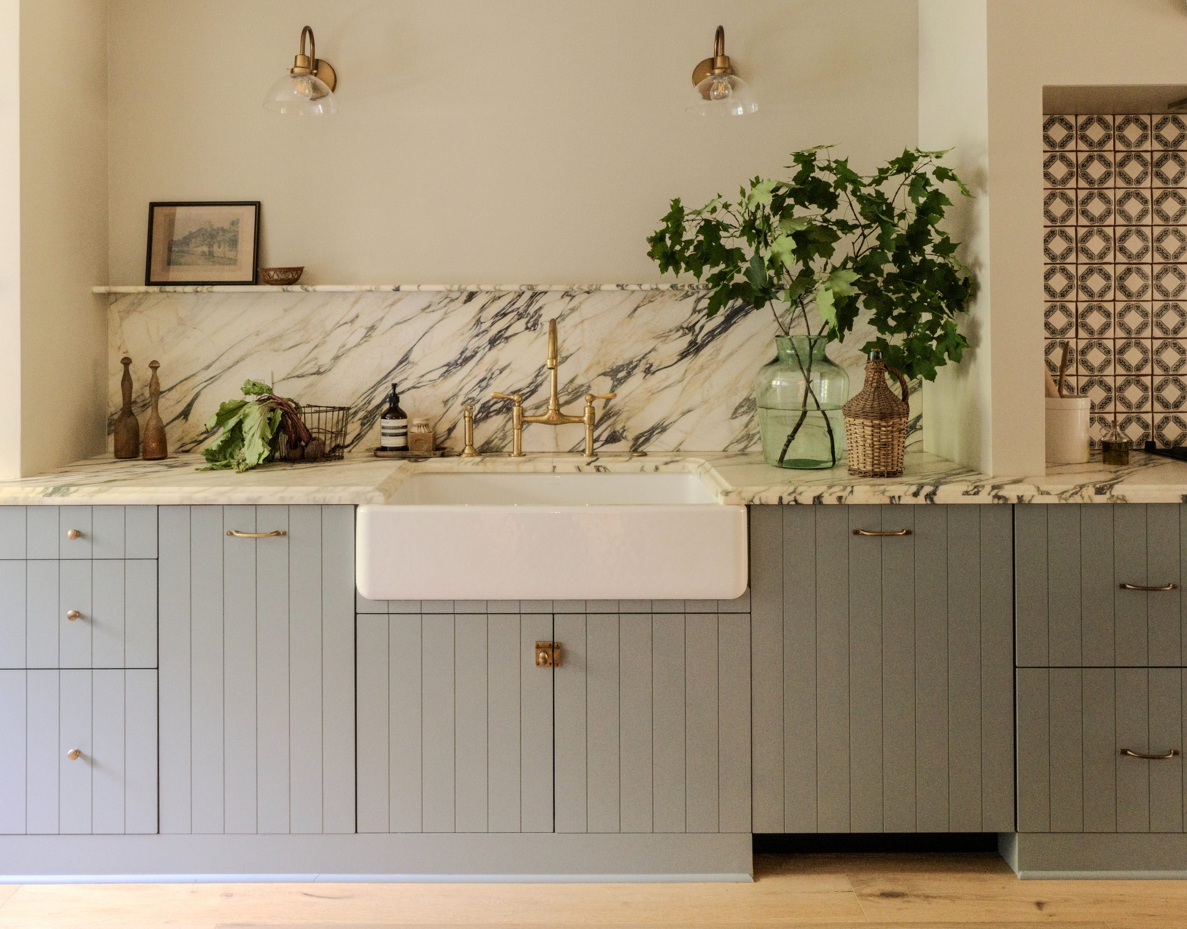 Westport, Connecticut kitchen with farmhouse sink, marble backsplash, and brass fixtures designed by Skilton House